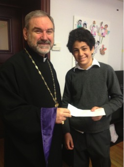 Aram Parnagian receives the answer to his question from Bishop Anoushavan. 